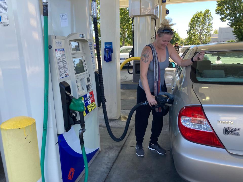 Clarrissa Clemens puts gas in her car Wednesday, Oct. 4, 2023, at the AM/PM gas station at Churn Creek Road and Mistletoe Lane in Redding, California, where the price of gasoline averages more than $5 a gallon.