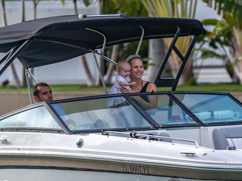 Boatsetter host Mylène Garot, a woman with her young baby and husband on a boat in Florida