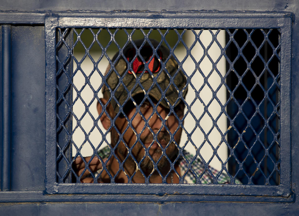 In this Oct. 12, 2019 photo, a Cuban exits a migrant shelter in Reynosa, Mexico. In years past, migrants seeking asylum in the United States moved quickly through this violent territory on their way to the U.S., but now due to Trump administration policies, they remain here for weeks and sometimes months as they await their U.S. court dates, often in the hands of gangsters who hold Tamaulipas state in a vice-like grip. (AP Photo/Fernando Llano)