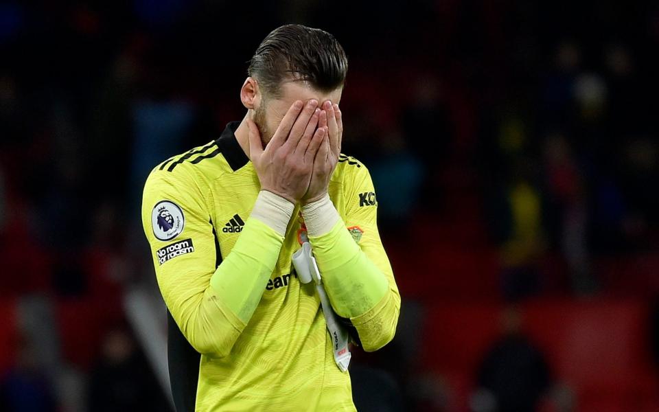David De Gea hides his face in shame after letting in five - AP Photo/Rui Vieira