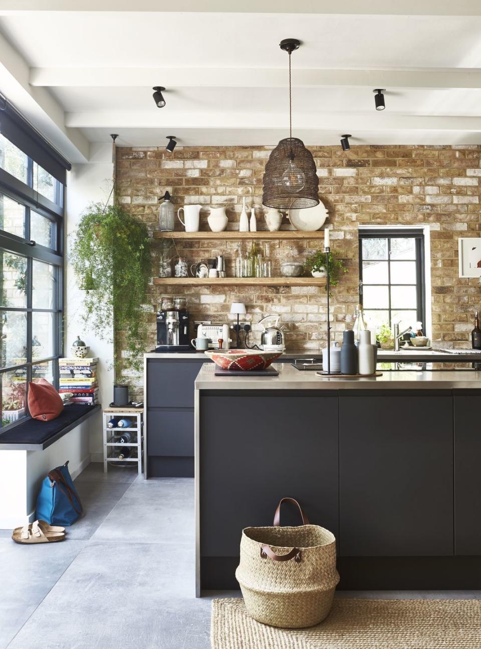 a kitchen with a stone wall