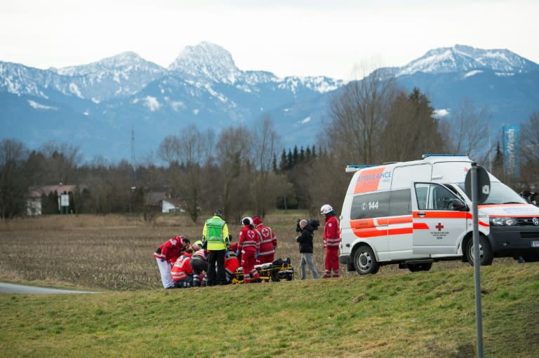 Paramedics work at the site of a train accident near Bad Aibling, southern Germany, on February 9, 2016