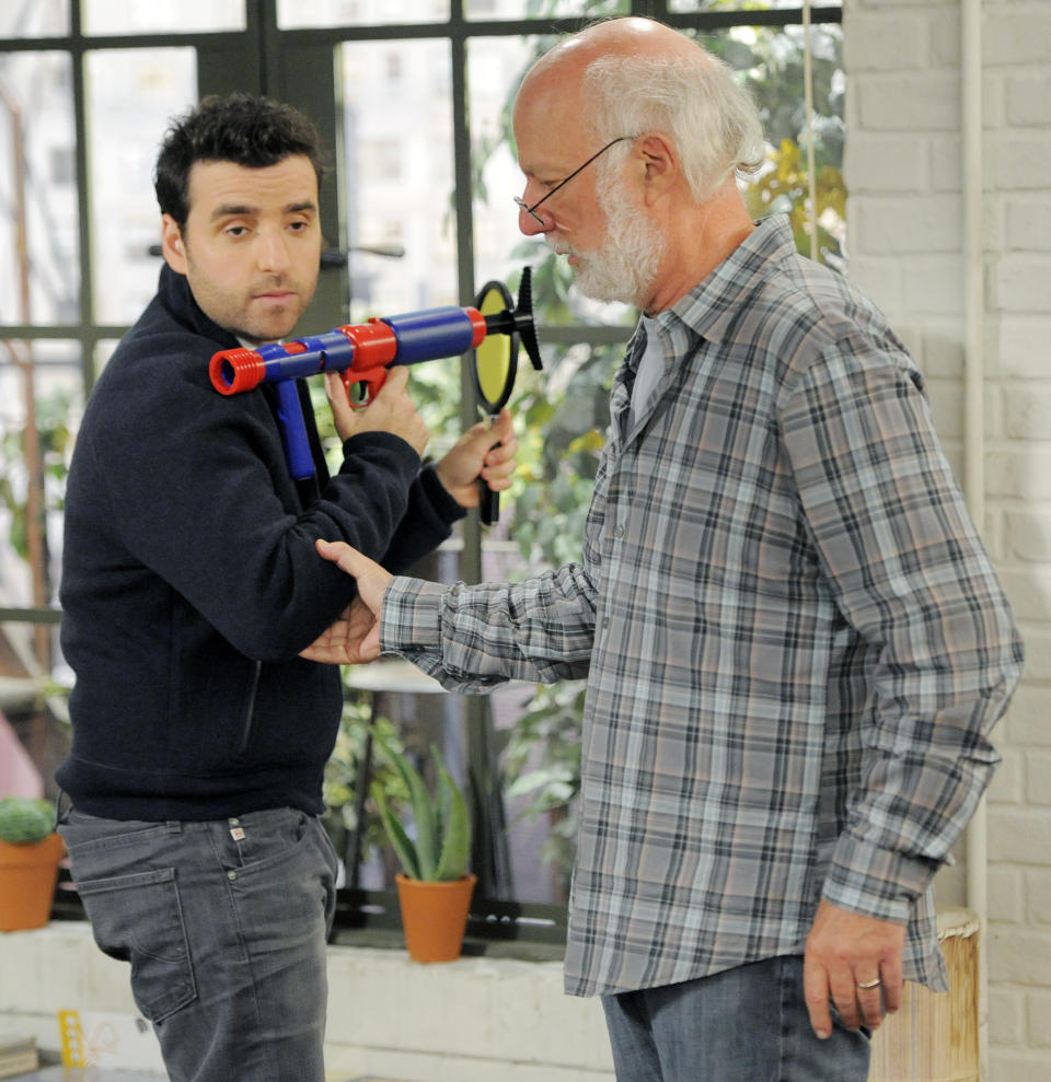 James Burrows, right, director of the television series "Partners," directs cast member David Krumholtz on the set on Wednesday, Sept. 19, 2012, at Warner Bros. Studios in Burbank, Calif. Burrows isn't a household name. But behind the scenes Burrows reigns as a comedy giant. He's a director whose brand of funny business has helped shape TV comedy season after season. (Photo by Chris Pizzello/Invision/AP)