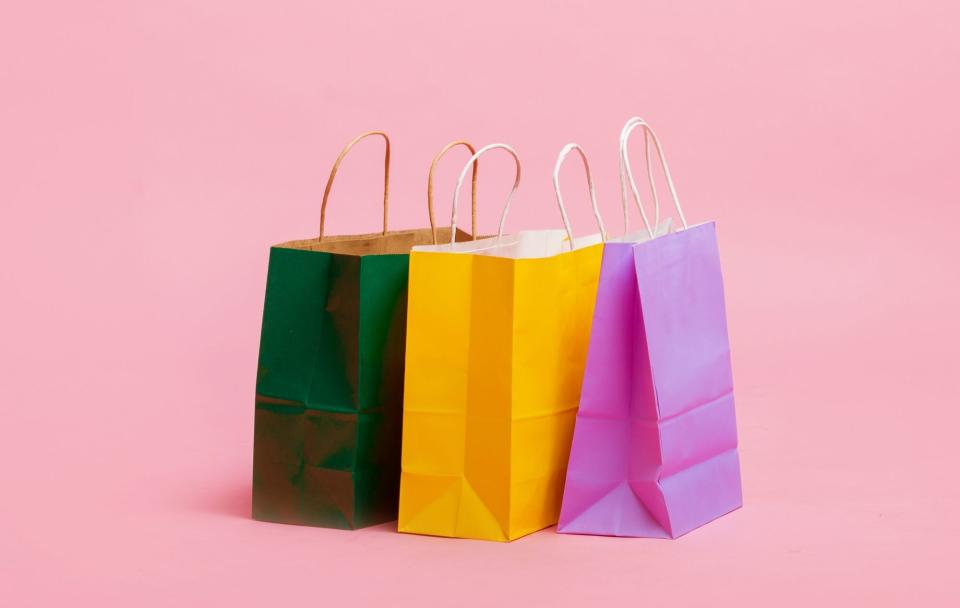 An image of shopping bags on a colorful background.