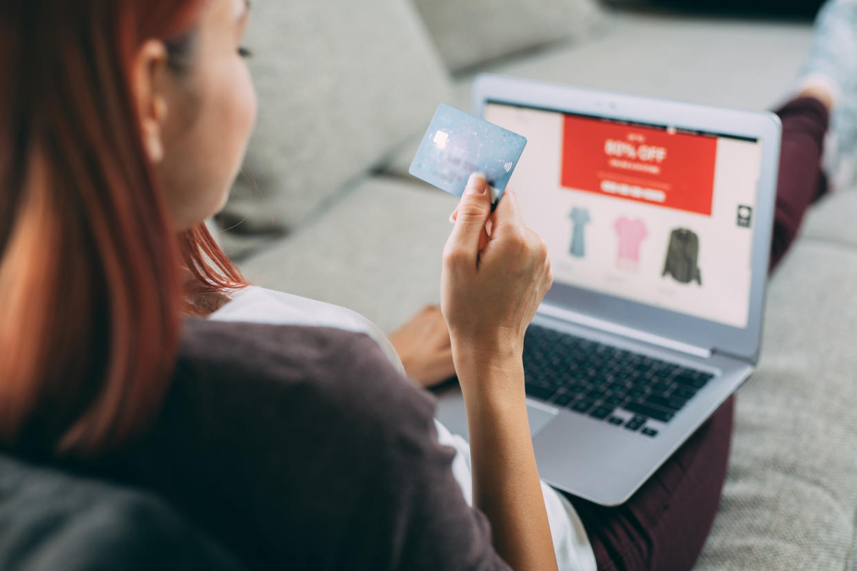 Woman making online payment via laptop at home. black friday online deals