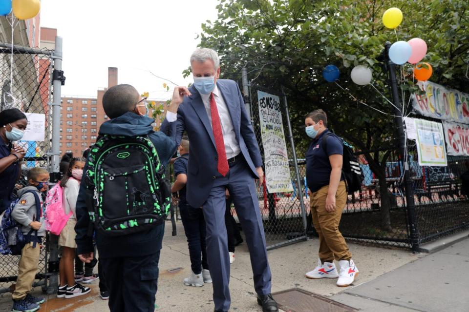 New York City Mayor Bill de Blasio elbow bumps a student at P.S. 188 as he welcomes elementary school students back to the city’s public schools for in-person learning on September 29, 2020 in New York City. (Photo by Spencer Platt/Getty Images)