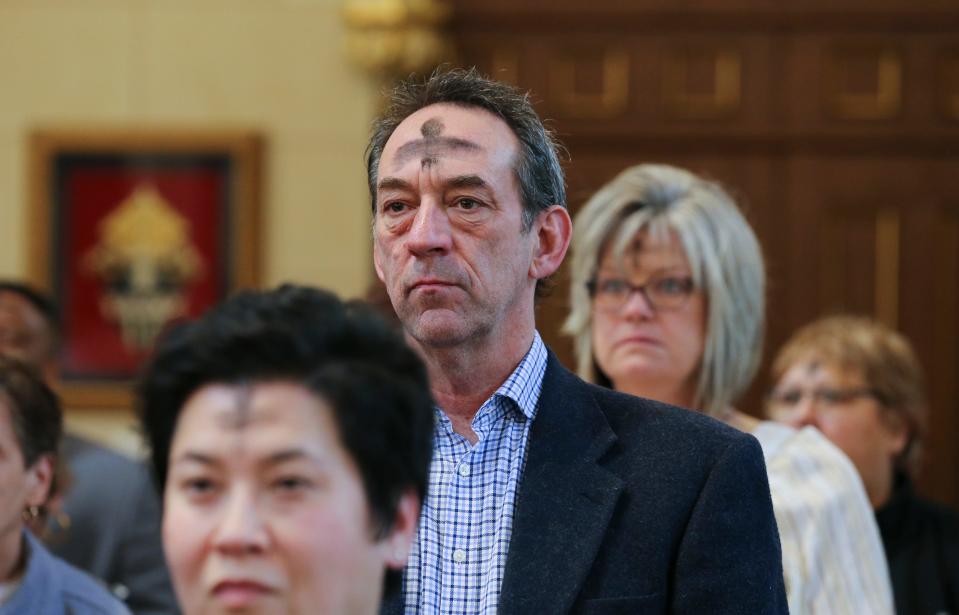 Bryan Lawson received ashes during the Ash Wednesday ceremony at the Cathedral of the Assumption in Louisville, Ky. on Feb. 22, 2023.  