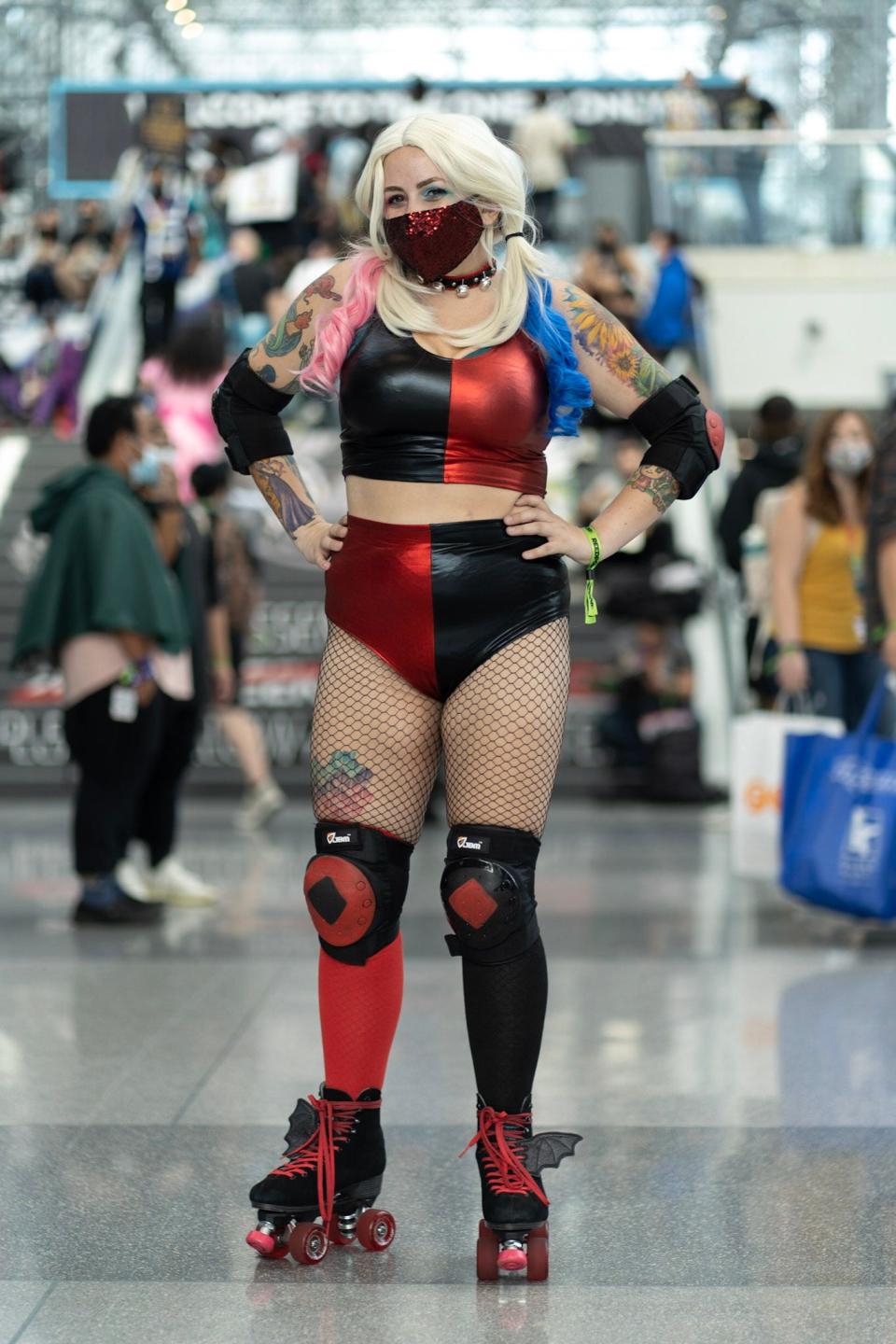 A cosplayer dressed as Harley Quinn on rollerblades at New York Comic Con 2021.