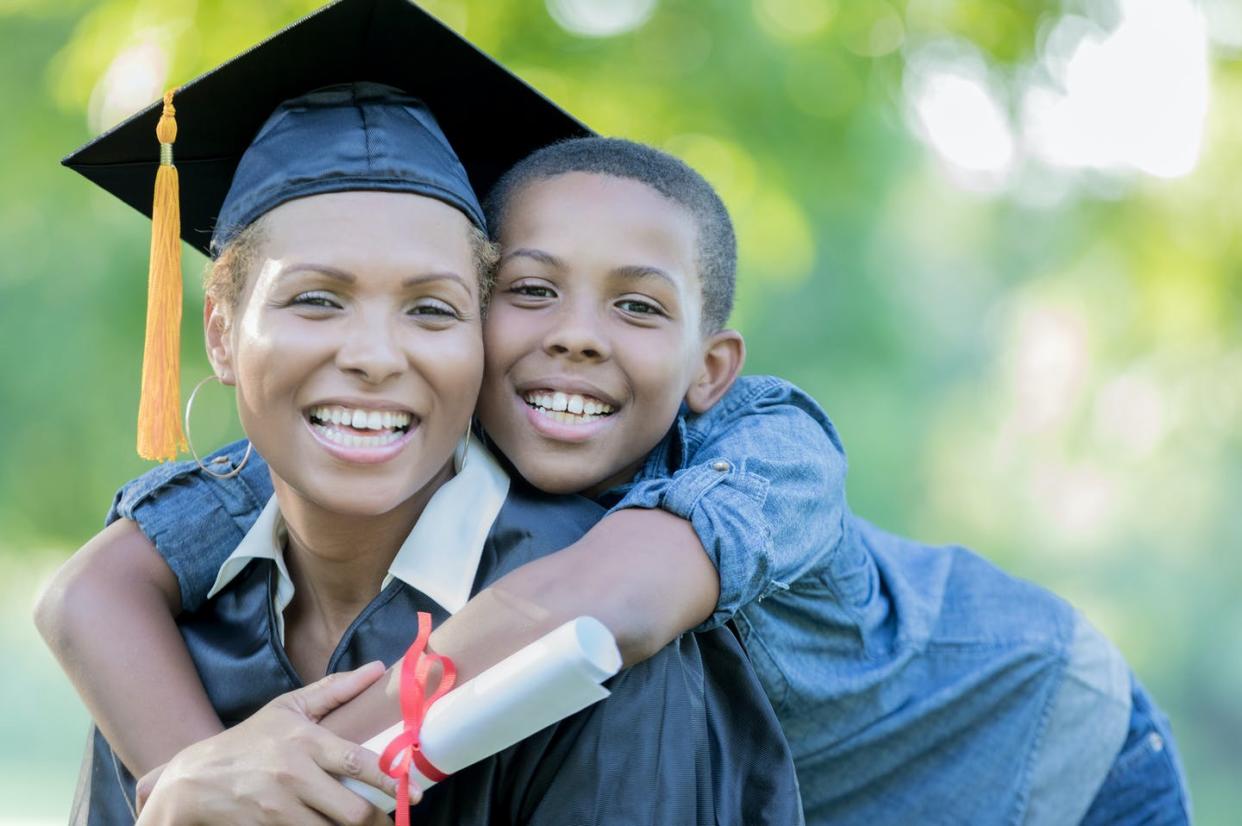 <span class="caption">A stable residence on campus can help college students who are parents complete their degrees.</span> <span class="attribution"><a class="link " href="https://www.gettyimages.com/detail/photo/tween-son-poses-with-mom-after-her-college-royalty-free-image/859125794?adppopup=true" rel="nofollow noopener" target="_blank" data-ylk="slk:SDI Productions/Getty Images;elm:context_link;itc:0;sec:content-canvas">SDI Productions/Getty Images</a></span>