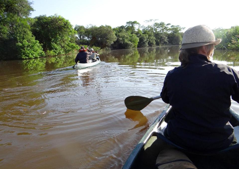This April 2012 photo shows guests and game rangers paddling along the Mzinene River in the Phinda Private Game Reserve, near the town of Hluhluwe, in Kwazulu-Natal province, South Africa. Phinda’s luxury lodges are spread over 56,000 acres and seven habitats, from the savanna to the unique sand forest. Rangers take visitors on drives to observe the Big Five (Cape buffalo, elephant, leopard, lion and rhino) and other animals roaming freely in protected open spaces. (AP Photo/Matthew Craft)