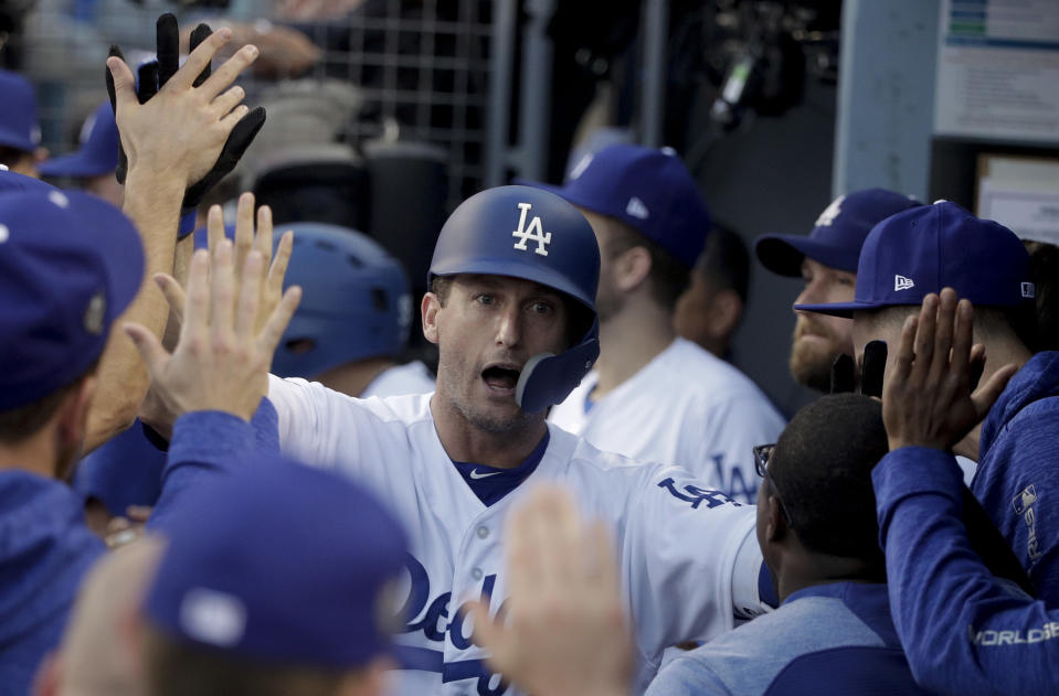 FILE - In this Oct. 28, 2018, file photo, Los Angeles Dodgers' David Freese celebrates in the dugout after hitting a home run against the Boston Red Sox during the first inning in Game 5 of the World Series baseball game in Los Angeles. Freese is retiring after a 10-year career that included a World Series title in 2011 with the St. Louis Cardinals when he was MVP. The 36-year-old infielder made the announcement Saturday, Oct. 12, 2019, on his verified Twitter account. (AP Photo/Jae C. Hong, File)