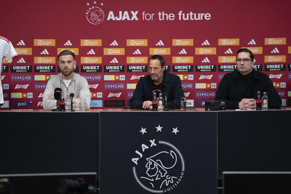 England midfielder Jordan Henderson, left, and Ajax trainer John van 't Schip, center, are seen during a news conference in Amsterdam, Netherlands, Friday, Jan. 19, 2024. The lucrative Saudi soccer league lost one of its high-profile players when Henderson quit Al-Ettifaq to sign for struggling Dutch powerhouse Ajax. (AP Photo/Peter Dejong)