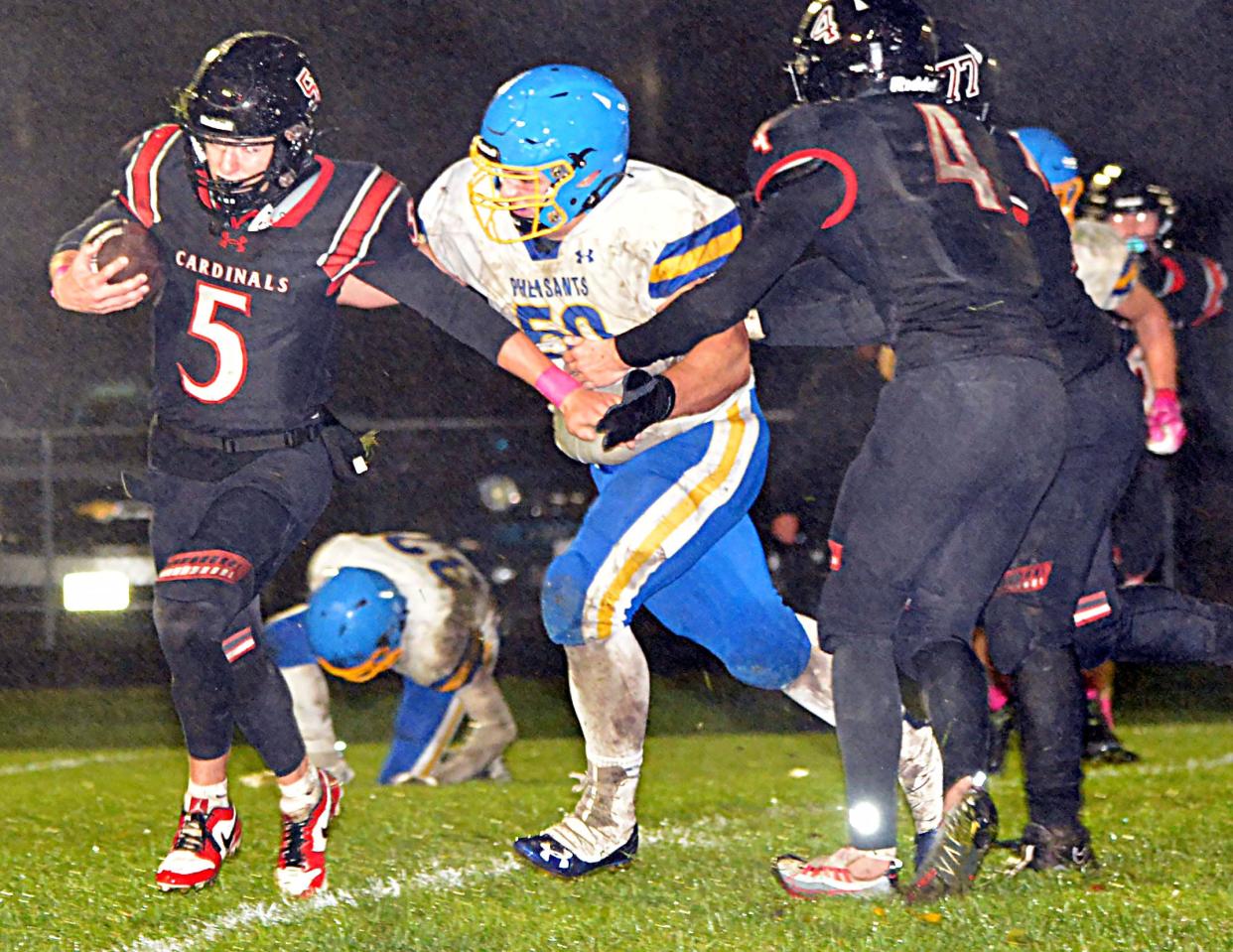 Redfield's Grady Fey gets after Deuel quarterback Trey Maaland during their high school football game on Friday, Oct. 13, 2023 in Clear Lake. The fifth-rated Class 11B Cardinals won 50-0.