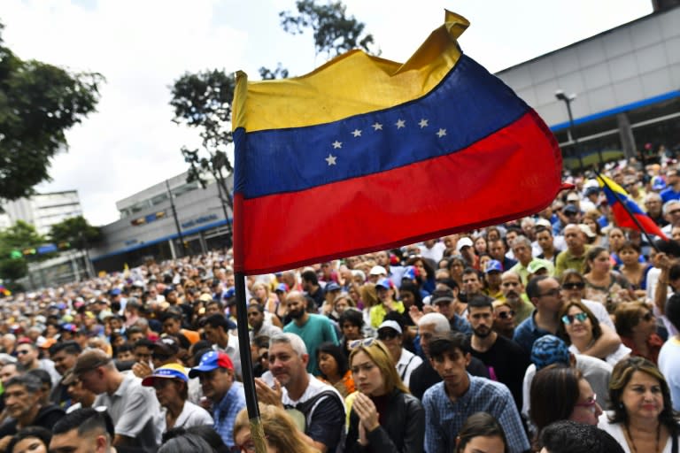 Anti-government activists listen to the president of Venezuela's opposition-led National Assembly Juan Guaido in Caracas on January 11, 2019