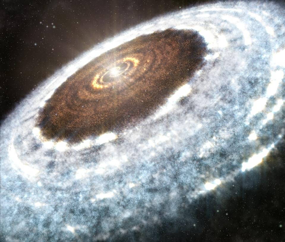 An artist's illustration shows the water snow line spotted around the young star V883 Orionis — the delineation between where the hot star vaporizes all water, leaving rocky dust and debris, and where ice and snow ex