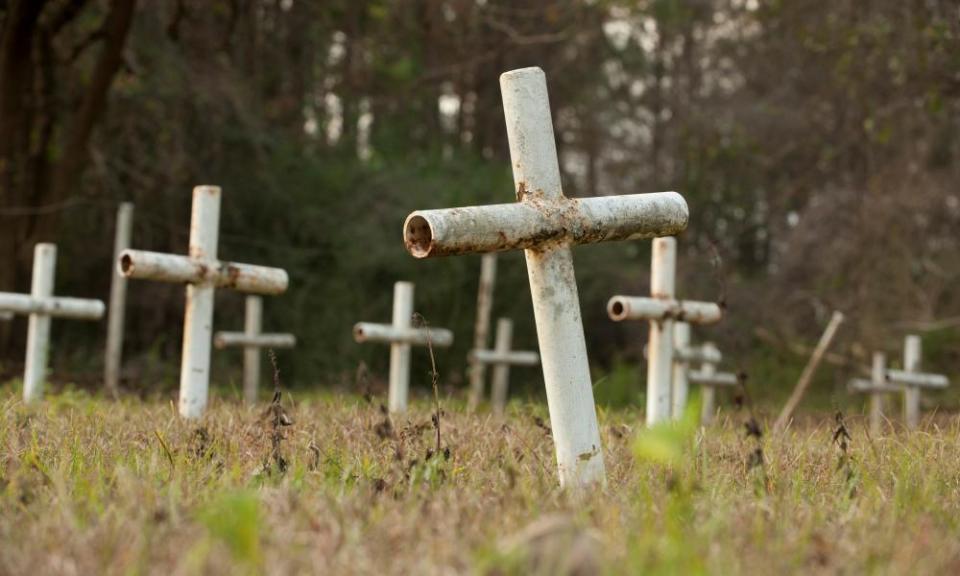 White metal crosses mark graves at the former Arthur G Dozier School for Boys in Marianna, Florida.