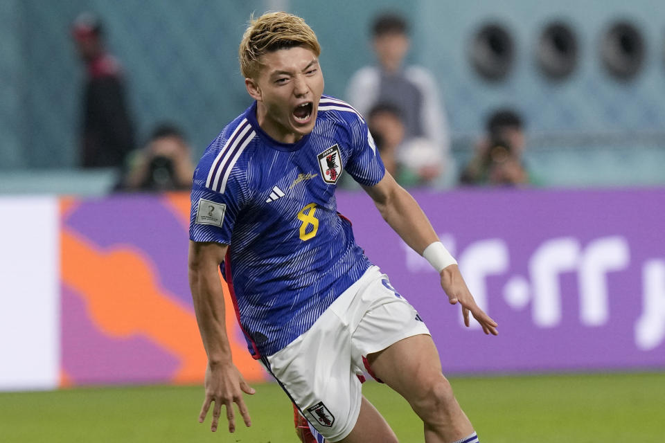 Japan's Ritsu Doan celebrates scoring his side's first goal against Spain during a World Cup group E soccer match at the Khalifa International Stadium in Doha, Qatar, Thursday, Dec. 1, 2022. (AP Photo/Eugene Hoshiko)