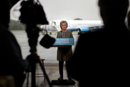 U.S. Democratic presidential candidate Hillary Clinton pauses as she speaks to the media before boarding her campaign plane at the Westchester County airport in White Plains, New York, U.S. September 19, 2016. REUTERS/Carlos Barria