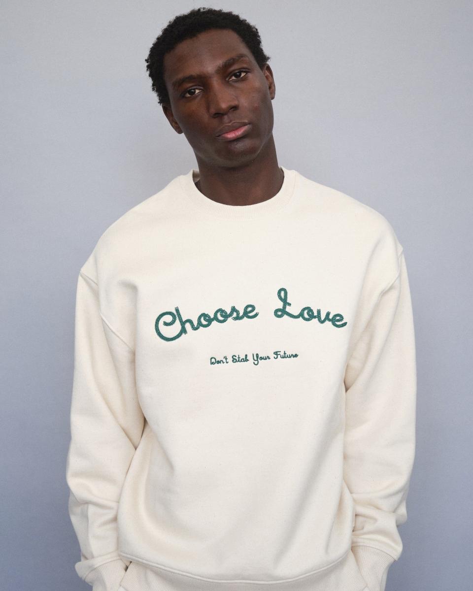 <p><a href="https://www.dsyf.com/collections/everything/products/dsyf-choose-love-cream-sweatshirt?variant=42437446664371" rel="nofollow noopener" target="_blank" data-ylk="slk:Shop Now;elm:context_link;itc:0;sec:content-canvas" class="link ">Shop Now</a></p><p>"Choose Love" Natural Raw Sweatshirt</p><p>dsyf.com</p><p>£75.00</p>