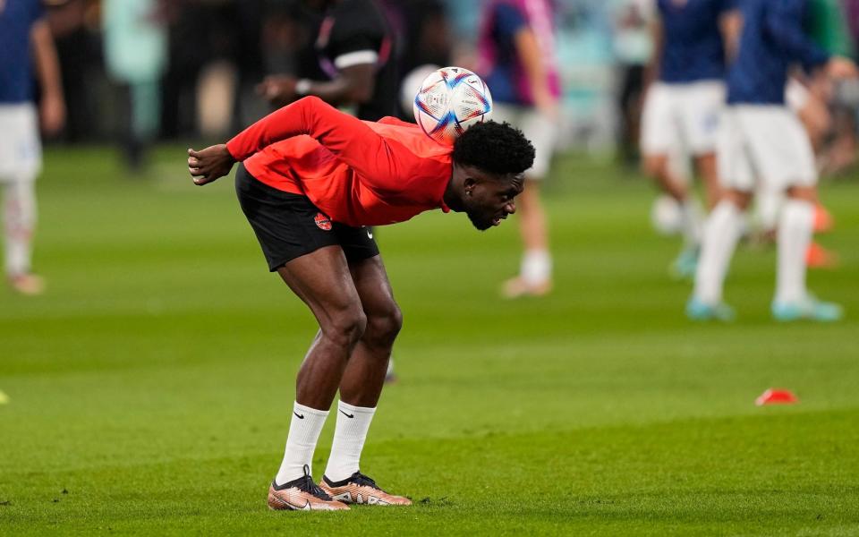 Canada's Alphonso Davies plays the ball during a warm up session prior the World Cup group F soccer match between Croatia and Canada, - Martin Meissner/AP