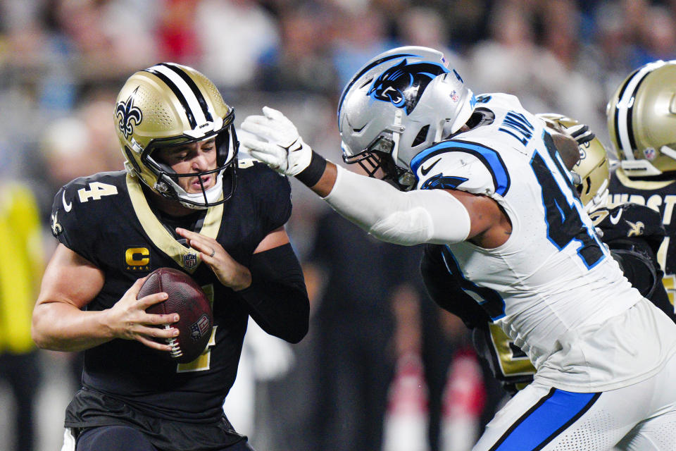 New Orleans Saints quarterback Derek Carr is sacked by Carolina Panthers linebacker Frankie Luvu during the first half of an NFL football game Monday, Sept. 18, 2023, in Charlotte, N.C. (AP Photo/Jacob Kupferman)