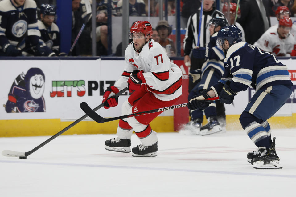 FILE - Carolina Hurricanes' Tony DeAngelo, left, crosses the blue line as Columbus Blue Jackets' Justin Danforth defends during the third period of an NHL hockey game Tuesday, April 16, 2024, in Columbus, Ohio. DeAngelo found himself playing a reduced role in his second stint with the Carolina Hurricanes amid a deep roster of defensemen. He could be headed for a larger role in the NHL playoffs with veteran Brett Pesce sidelined by injury. (AP Photo/Jay LaPrete, File)