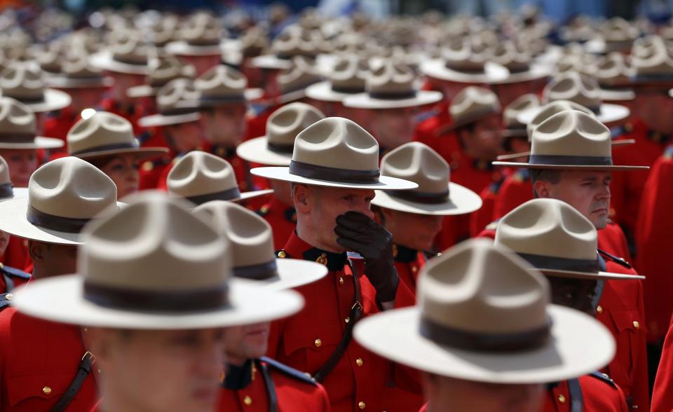 Royal Canadian Mounted Police officers gather to attend the funeral for three fellow officers who were killed last week in Moncton