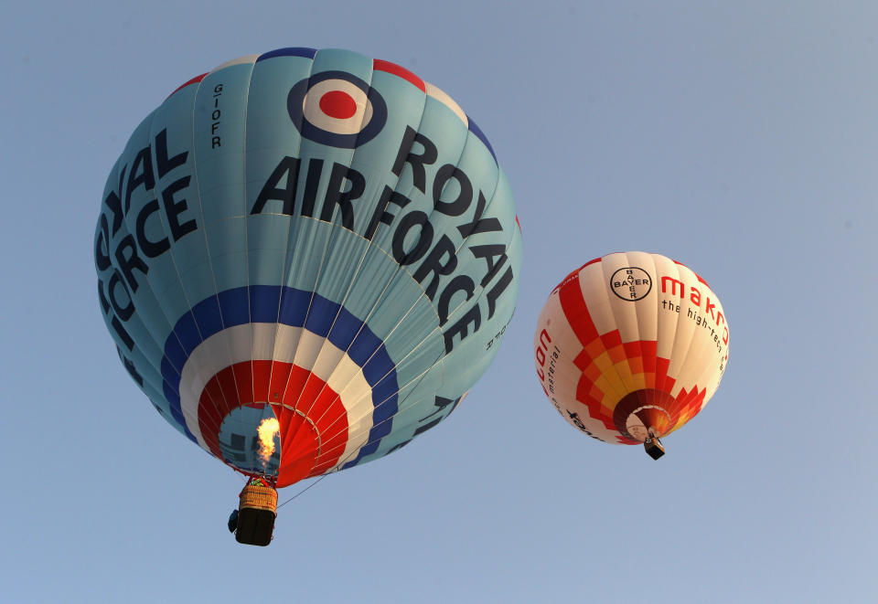 WOOTTON, UNITED KINGDOM - APRIL 07: Hot air balloons depart from Lydden Hill race circuit near Canterbury to take part in a mass crossing of the Channel on April 7, 2011 in Wootton, England. 51 balloonists of various nationalities from across Europe took off from Kent making for Calais, France at about 7am. It is the first time a Guinness World Record bid has been made for "the largest group of hot air balloons to make the Channel crossing". (Photo by Oli Scarff/Getty Images)