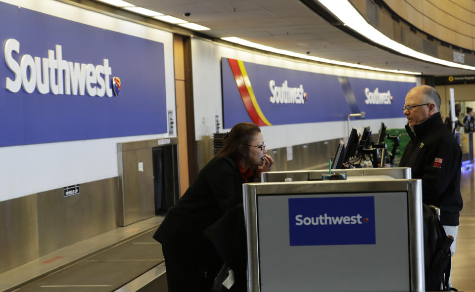 FILE - In this March 13, 2019, file photo a traveler checks in with Southwest Airlines at Seattle-Tacoma International Airport in Seattle. Southwest Airlines Co. reports earns on Thursday, April 25. (AP Photo/Ted S. Warren, File)