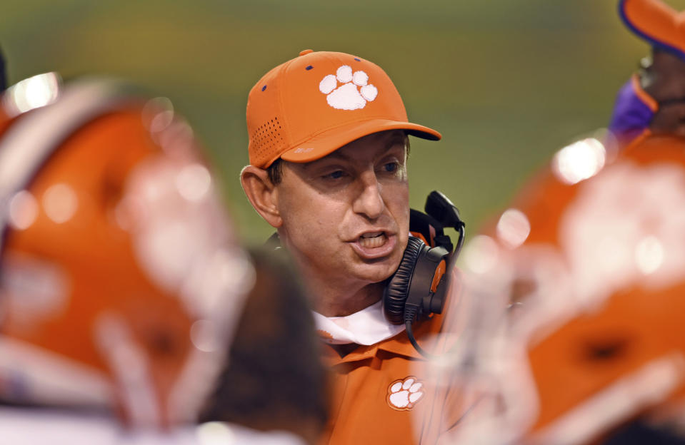 Clemson coach Dabo Swinney talks with players after a defensive stop against Wake Forest during an NCAA college football game Saturday, Sept. 12, 2020, in Winston-Salem, N.C. (Walt Unks/The Winston-Salem Journal via AP)