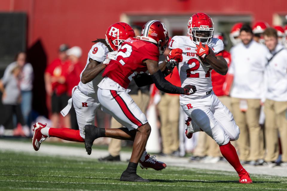 Oct 21, 2023; Bloomington, Indiana, USA; Rutgers Scarlet Knights running back Samuel Brown V (27) runs the ball in front of Indiana Hoosiers defensive back Jamari Sharpe (22) during the second half at Memorial Stadium. Mandatory Credit: Marc Lebryk-USA TODAY Sports