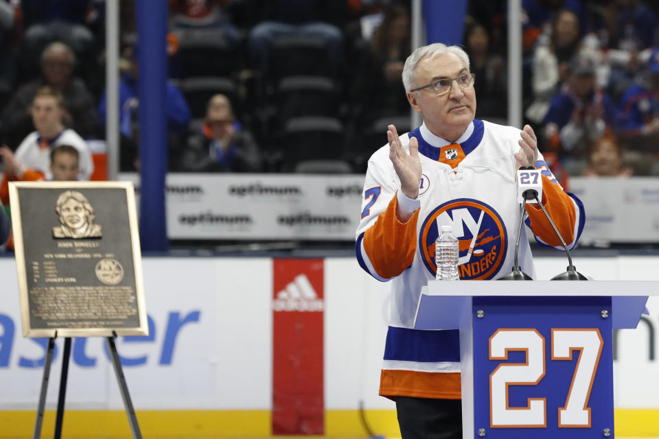 Former New York Islander John Tonelli applauds during his jersey retirement ceremony Friday, Feb. 21, 2020, in Uniondale, N.Y. (AP Photo/Kathy Willens)