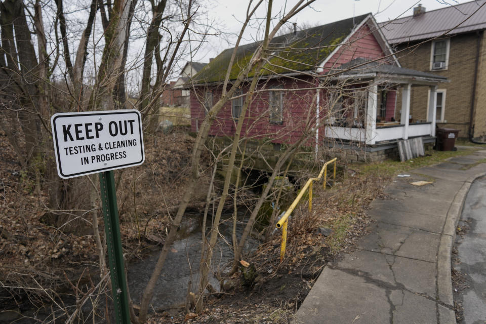 FILE - A sign reads "Keep Out Testing & Cleaning in Progress" near the Sulphur Run Creek as it flows under homes in East Palestine, Ohio, on Jan. 30, 2024. The Internal Revenue Service decided Wednesday, June 5, 2024, that most people who received money from Norfolk Southern in the wake of the train derailment won't have to pay taxes on millions of dollars in aid payments. (AP Photo/Carolyn Kaster, File)