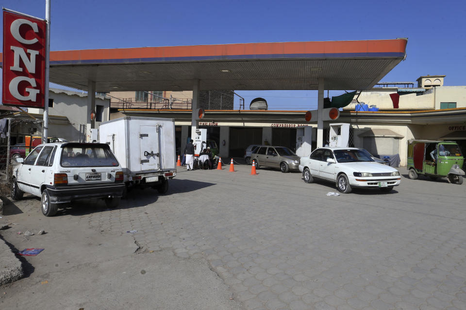 People wait their turn for filling gas into their car. at a CNG station, in Peshawar, Pakistan, Tuesday, Feb. 14, 2023. Cash-strapped Pakistan nearly doubled natural gas taxes Tuesday in an effort to comply with a long-stalled financial bailout, raising concerns about the hardship that could be passed on to consumers in the impoverished south Asian country. Pakistan's move came as the country struggles with instability stemming from an economic crisis. (AP Photo/Muhammad Sajjad)