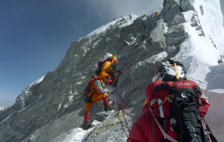 Mountaineers walk past the Hillary Step while pushing for the summit of Mount Everest on the south face from Nepal, in a file photo from 2009