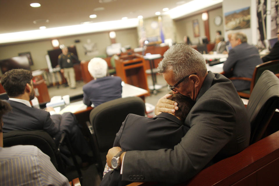 FILE - Gavin Cox holds his wife Minh-Hahn Cox as they wait for the jury's decision in his trial against illusionist David Copperfield at the Regional Justice Center in Las Vegas on Tuesday, May 29, 2018. The Nevada Supreme Court has upheld a jury’s findings that illusionist David Copperfield and the MGM Grand weren't financially responsible for a British tourist’s injuries during a Las Vegas Strip show in 2013. (Rachel Aston/Las Vegas Review-Journal via AP)