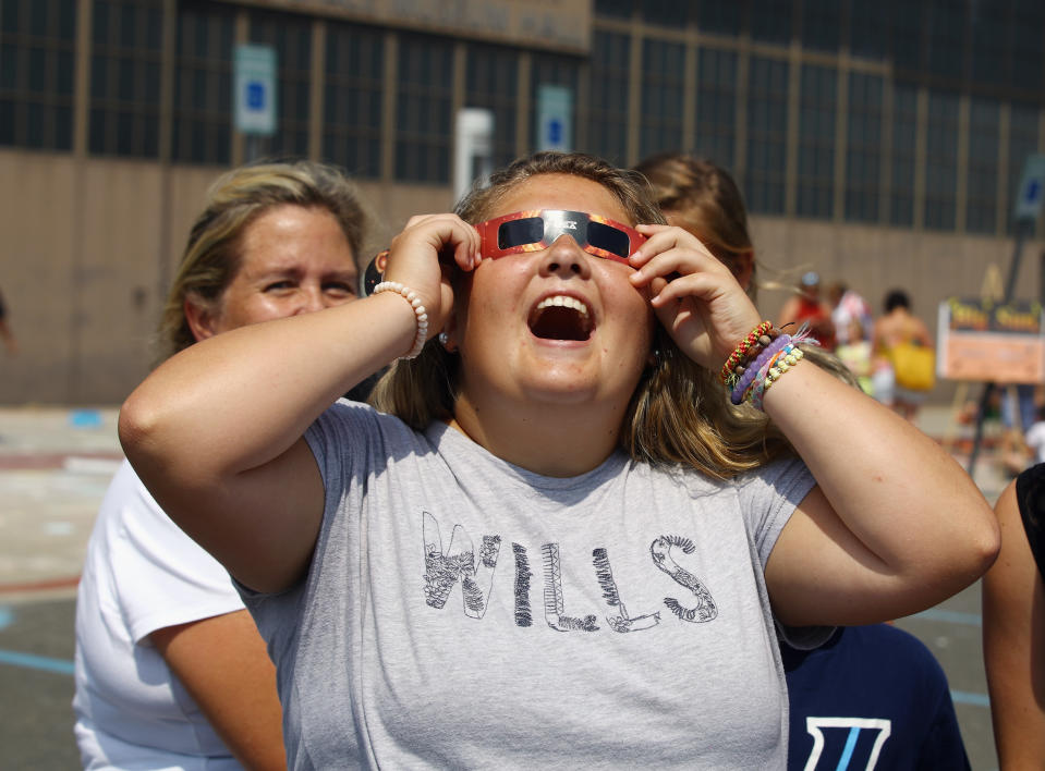 A spectator looks skyward during a partial eclipse of the sun on Aug. 21, 2017 at the Cradle of Aviation Museum in Garden City, New York.  / Credit: Bruce Bennett/Getty Images