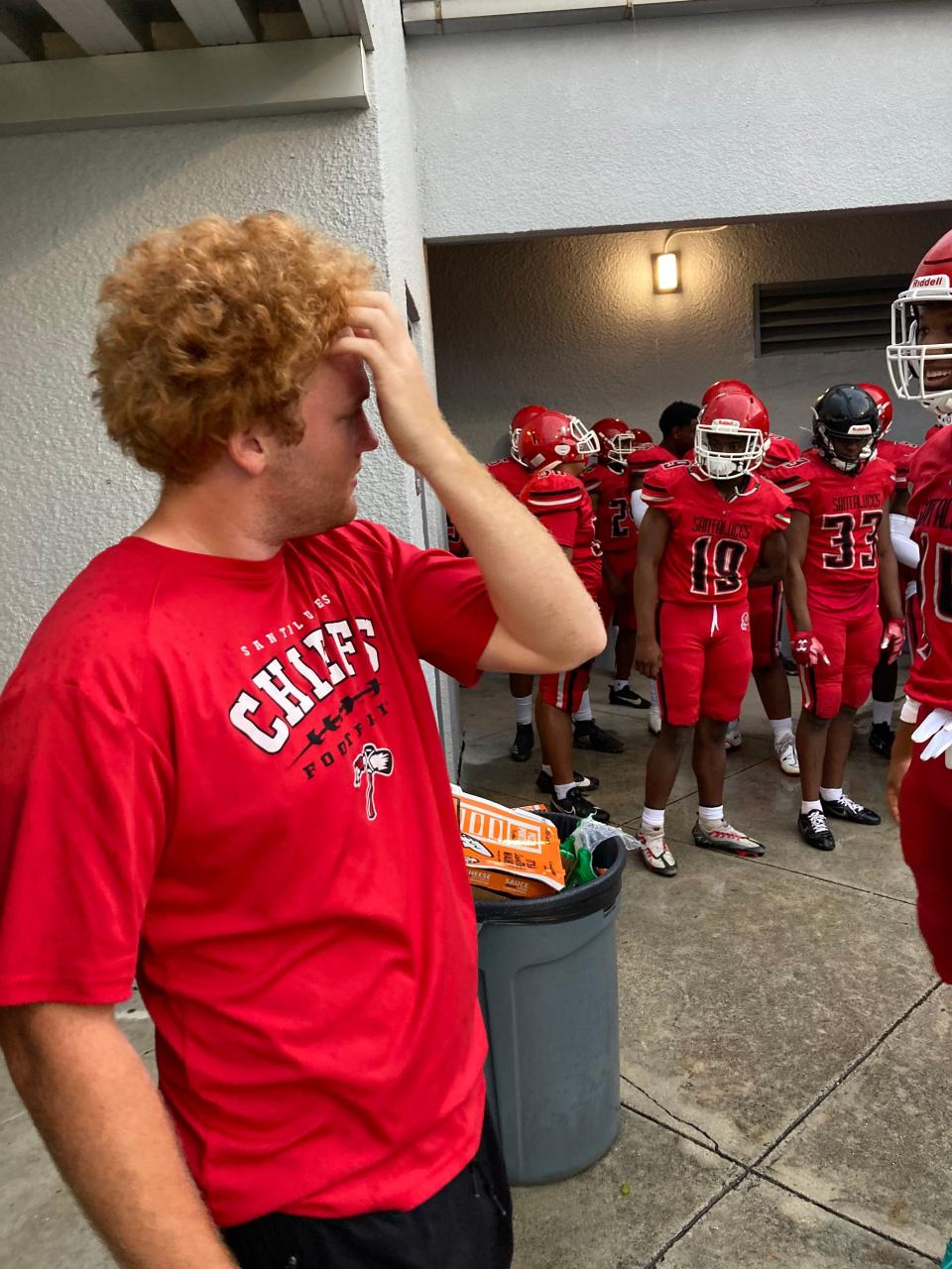 Former Santaluces quarterback Will Prichard, left, now at Arkansas State, stands with the Chiefs before a spring game against South Broward on Thursday in Lantana.