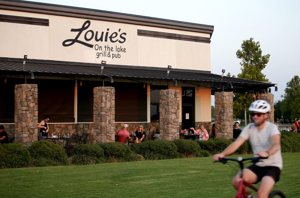 People eat outside at Louie’s Grill & Bar at Lake Hefner in Oklahoma City. Louie's is one of several Hal Smith restaurants that closed Wednesday to allow employees to attend a day of advocacy at the state capitol.