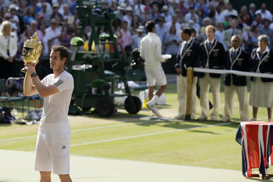 FILE - In this July 7, 2013, filemphoto, Andy Murray of Britain poses with the trophy after defeating Novak Djokovic of Serbia in the men's singles final match at the All England Lawn Tennis Championships in Wimbledon, London. (AP Photo/Alastair Grant, File)