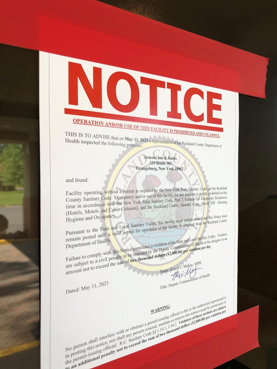 A notice on the front door of the Armoni Inn & Suites in Orangeburg, seen Thursday, May 17, 2023, states that operation of the facility is prohibited. The hotel had been one that contracted with New York City to house single male asylum seekers.