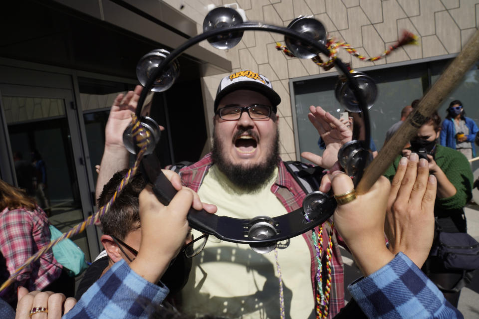 CORRECTS CAPTION TO REMOVE REFERENCE TO GESUALDI USING PROFANITIES, WHICH HE DID NOT DO AT THE MOMENT THE IMAGE WAS MADE. ALSO REMOVES REFERENCE TO PROTESTERS BEING PEACEFUL BECAUSE ONE PROTESTER DESTROYED HIS SIGN - Comedian and videographer Vito Gesualdi shouts at people protesting against Dave Chappelle's Netflix special outside the Netflix building in the Hollywood section of Los Angeles, Wednesday, Oct. 20, 2021. Critics and supporters of the show and its anti-transgender comments gathered outside the company's offices Wednesday with "Trans Lives Matter" and "Free Speech is a Right" among their competing messages. (AP Photo/Damian Dovarganes)