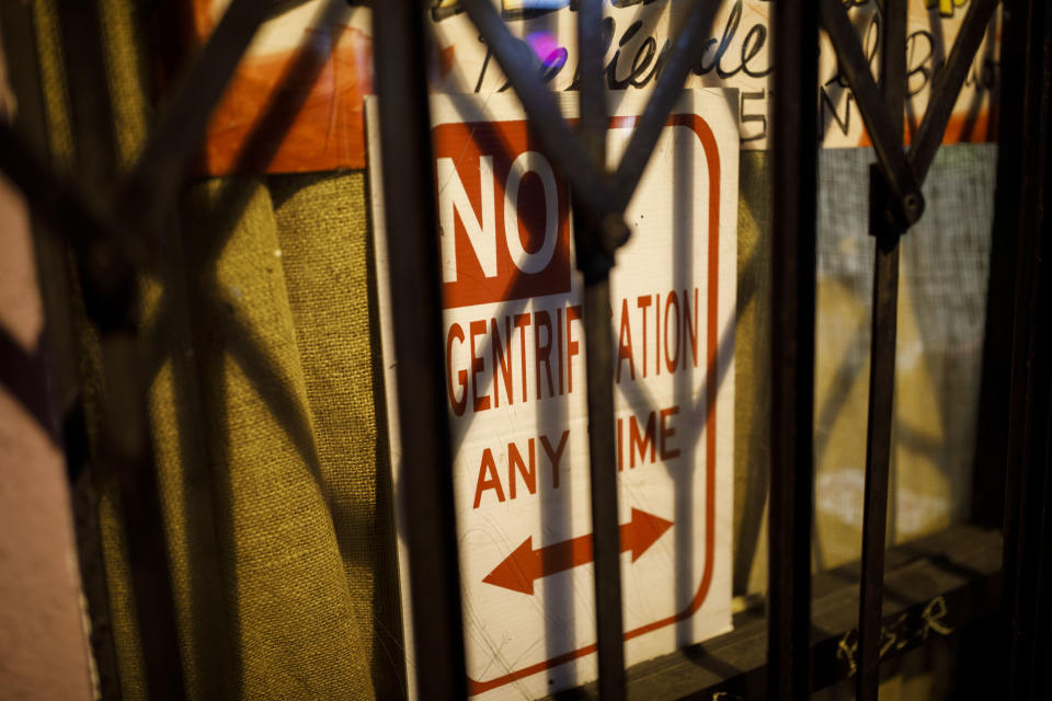 A sign saying “No Gentrification Any Time” is dispayed in the window of the La Conxa Autonomous Community Space in Boyle Heights, Los Angeles. (Photo: Patrick T. Fallon for Yahoo News)