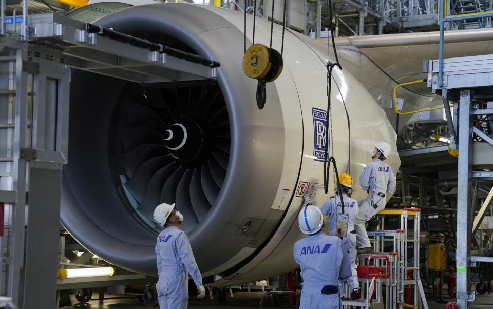 Technical staff members prepare one of the Rolls-Royce Holdings Plc engines of a Boeing Co - Toru Hanai/Bloomberg