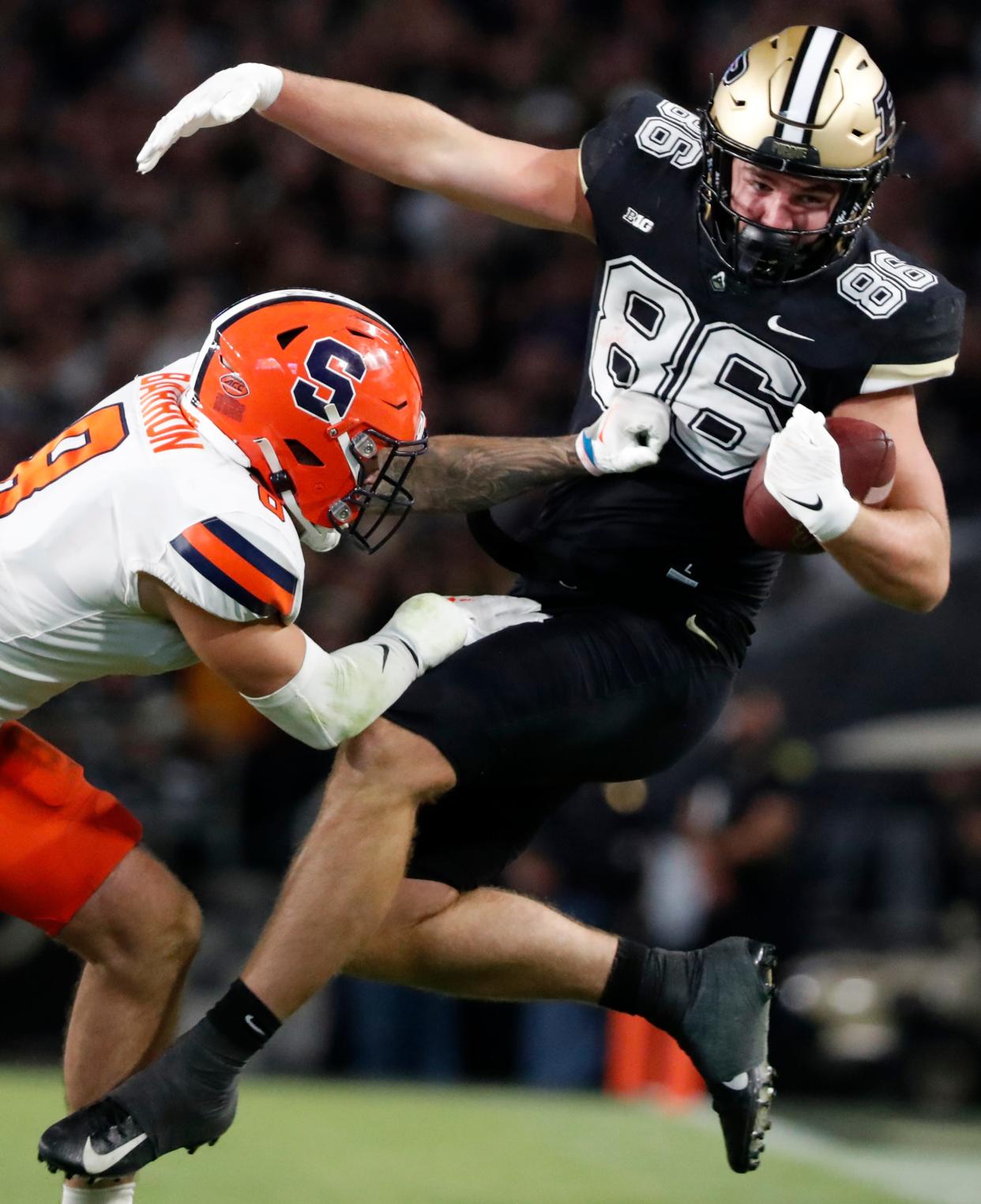 Syracuse Orange defensive back Justin Barron (8) tackles Purdue Boilermakers tight end Max Klare (86) during the NCAA football game, Wednesday, July 12, 2023, at Ross-Ade Stadium in West Lafayette, Ind. Syracuse Orange won 35-20.