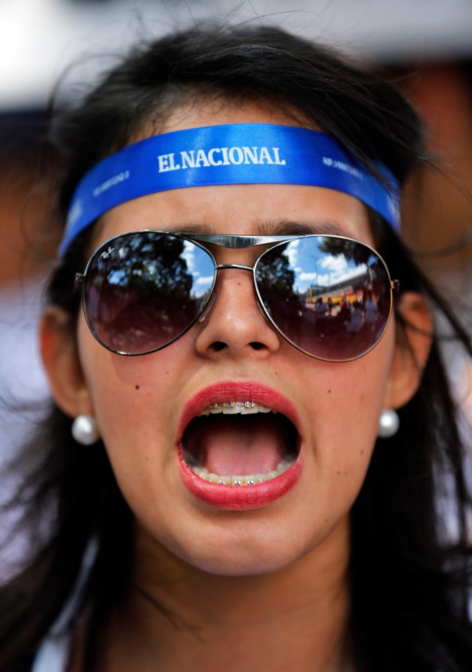 An employees of the newspaper El Nacional shouts slogans against Venezuela's President Nicolas Maduro, during a protest outside the Cadivi agency, which controls foreign currency in Caracas, Venezuela, Tuesday, Jan. 28, 2014. While newspapers have been beset for years by currency controls that make it difficult to import supplies, El Nacional is scrambling for newsprint as worsening shortages threaten to take several publications out of circulation in the coming weeks as reserves of newsprint have fallen to an all-time low. (AP Photo/Fernando Llano)