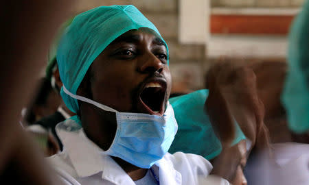 A Kenyan doctor shouts a slogan to demand fulfilment of a 2013 agreement between their union and the government that would raise their pay and improve working conditions at a meeting in Nairobi, Kenya December 5, 2016. REUTERS/Thomas Mukoya