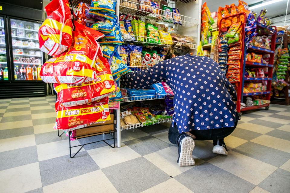 Antonia stocks the shelves at a convenience store in the Florida Panhandle on Thursday, June 8, 2023. 