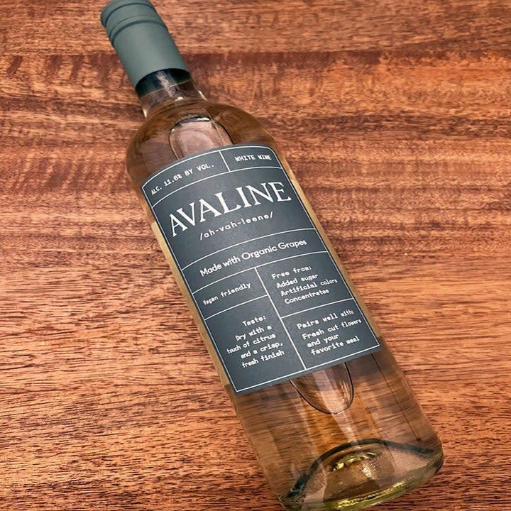 A bottle of white wine on a wooden table