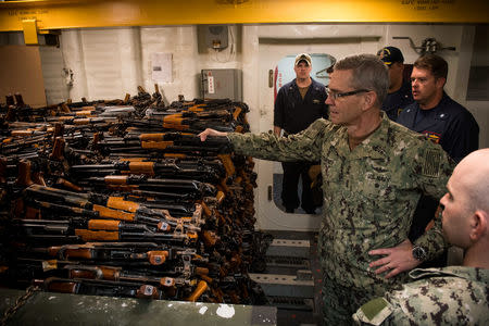 FILE PHOTO: Vice Admiral Scott Stearney, commander of U.S. Naval Forces Central Command, U.S. 5th Fleet and Combined Maritime Forces, looks at a cache of over 2,500 AK-47 automatic rifles seized during maritime security operations aboard the guided-missile destroyer USS Jason Dunham in Manama, Bahrain October 24, 2018. U.S. Navy/Mass Communication Specialist 3rd Class Jonathan Clay/Handout via REUTERS/File Photo